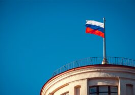 photograph of a russia flag under a blue sky
