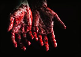 person s hands covered with blood