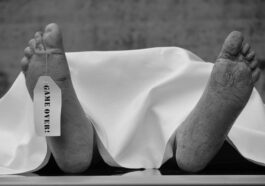 grayscale photo of persons feet on white textile