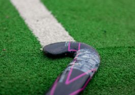 close up of field hockey stick on turf