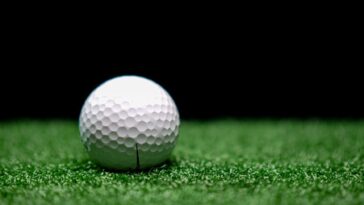 a golf ball on the artificial turf grass