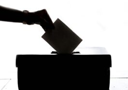 person dropping paper on box