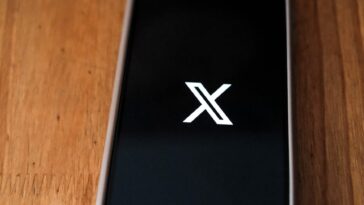 smartphone with social media icon on desk